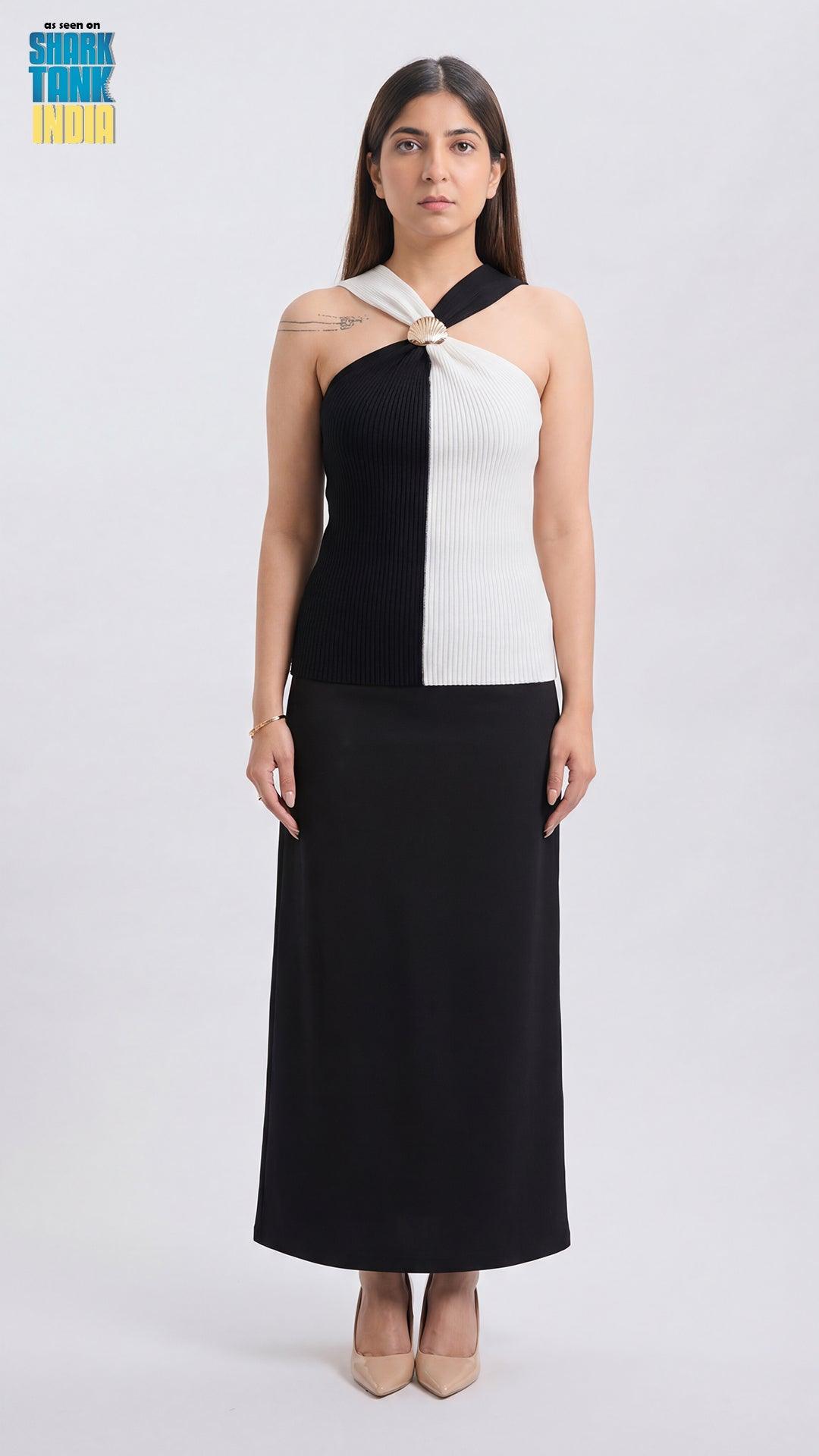 Woman wearing a black and white dress on a white background