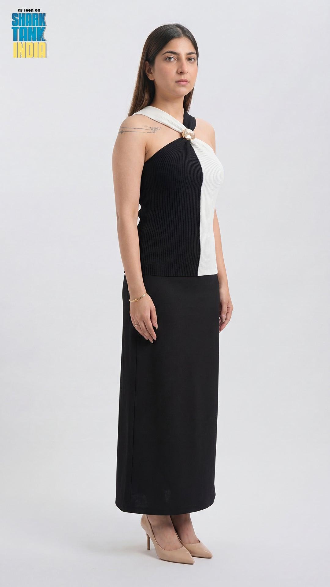 Woman wearing a black and white dress on a white background
