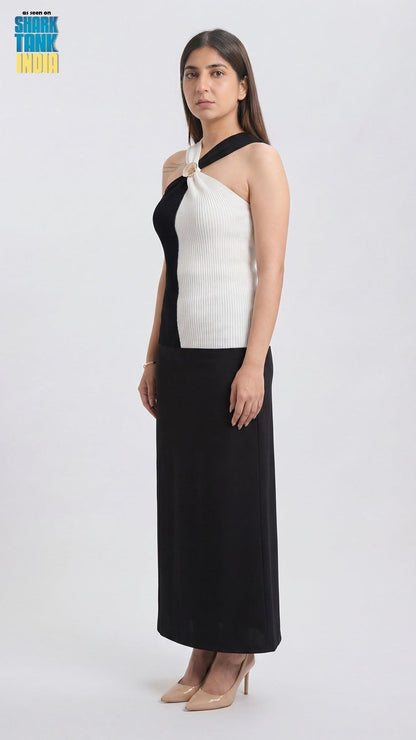 Woman wearing a black and white dress on a white background