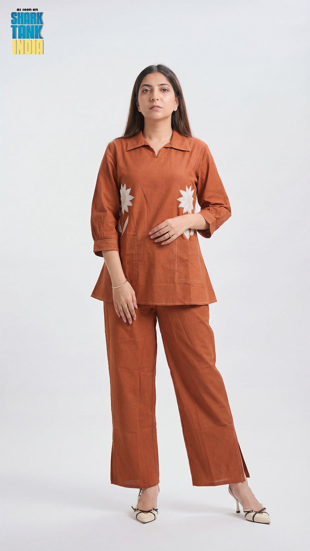 Woman wearing a brown outfit with floral patterns on a white background