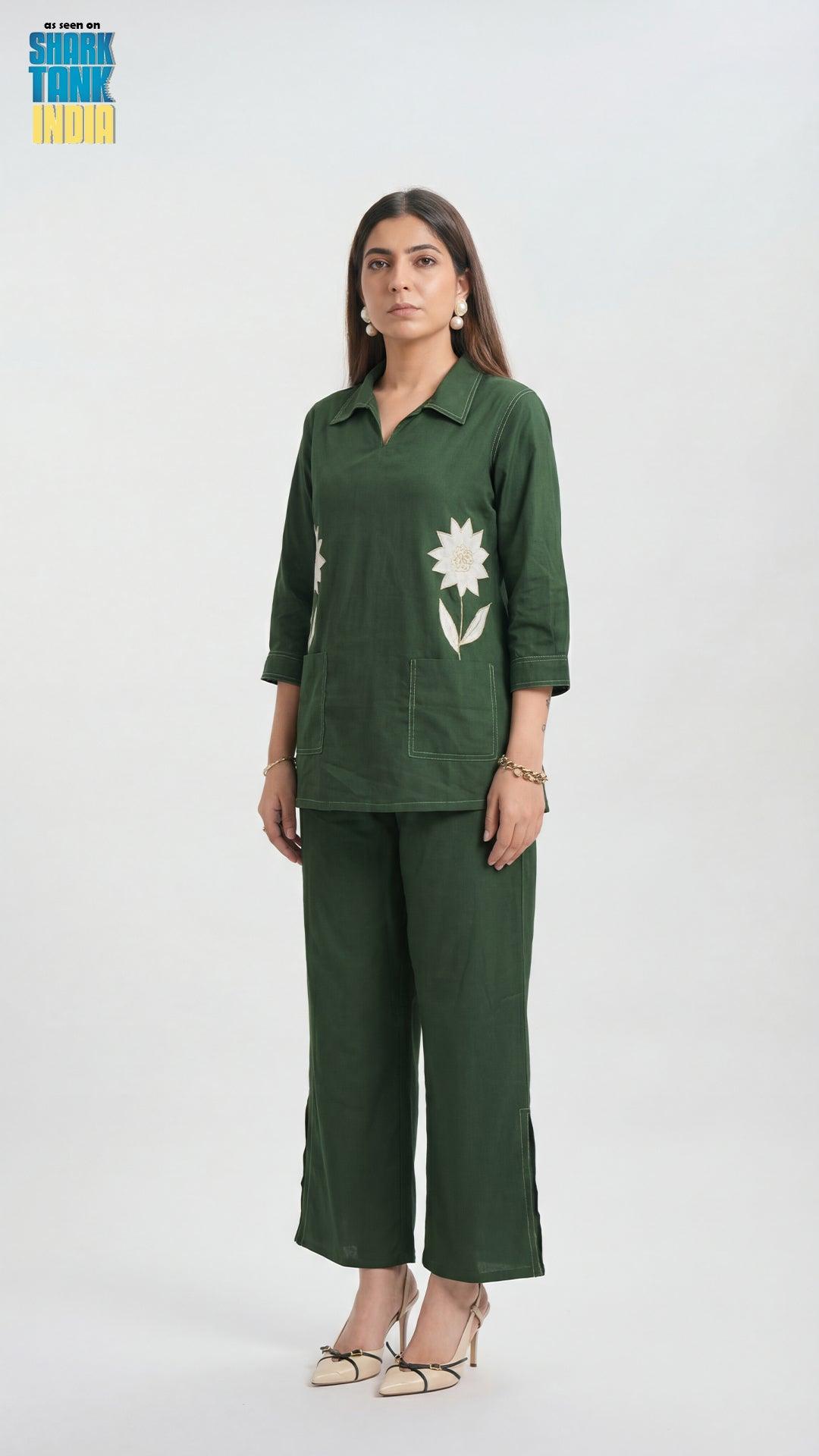 Woman wearing a green outfit with floral design on a white background