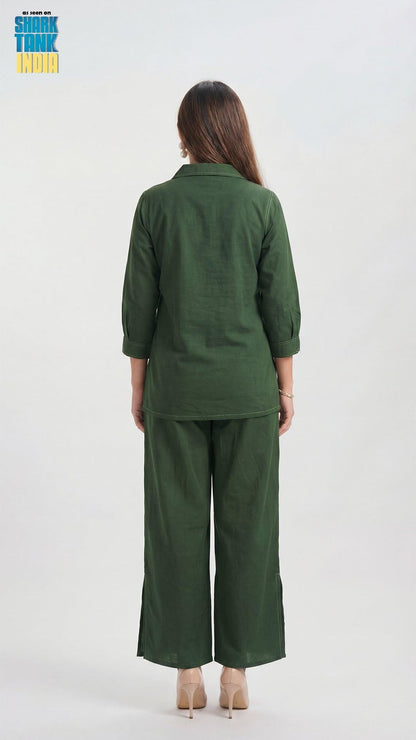Person wearing a green outfit with wide-leg pants on a white background