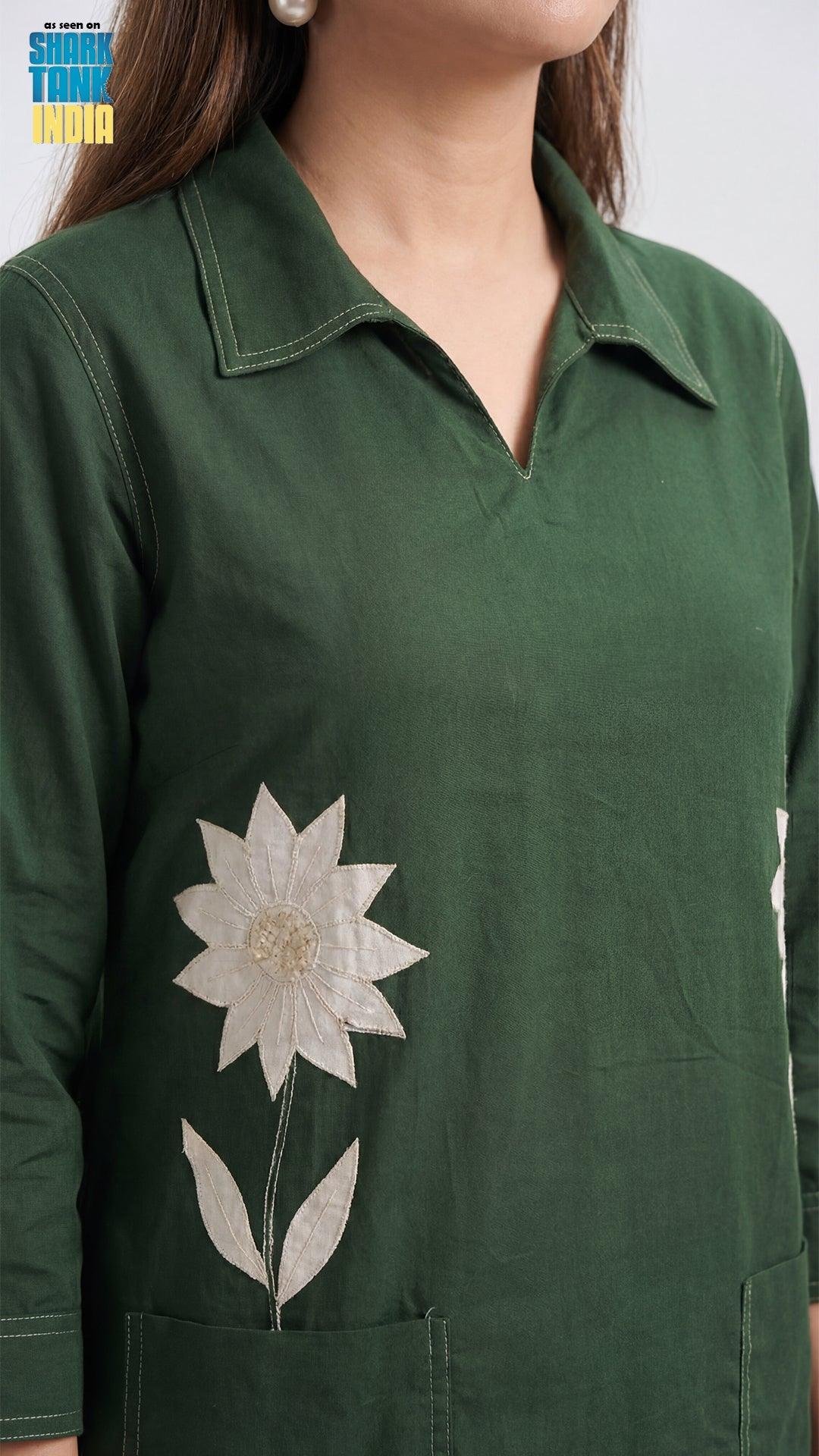 Green shirt with a white floral design on a plain background