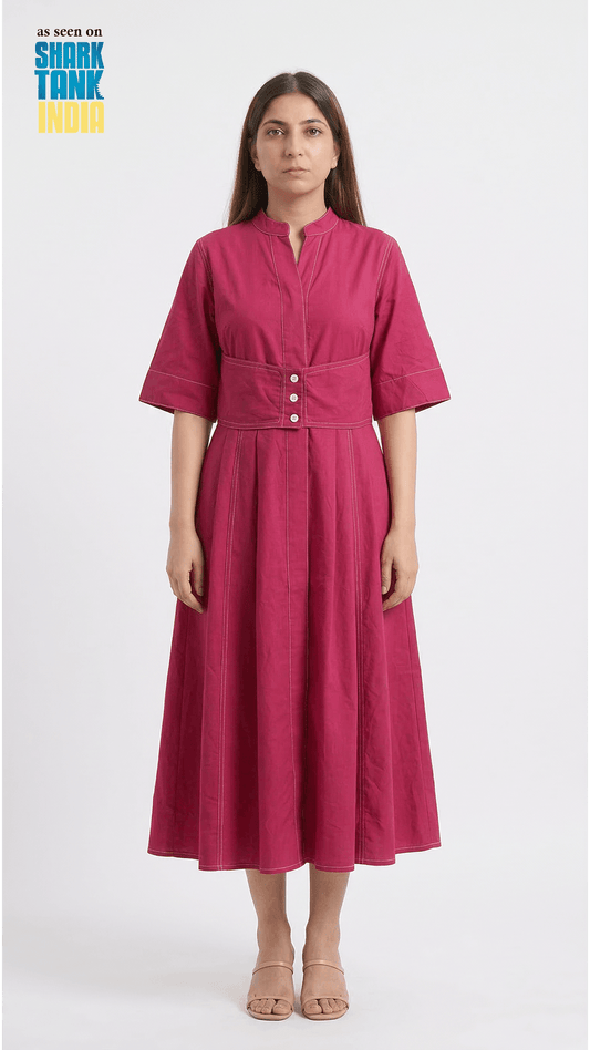 Woman wearing a pink dress with a white background