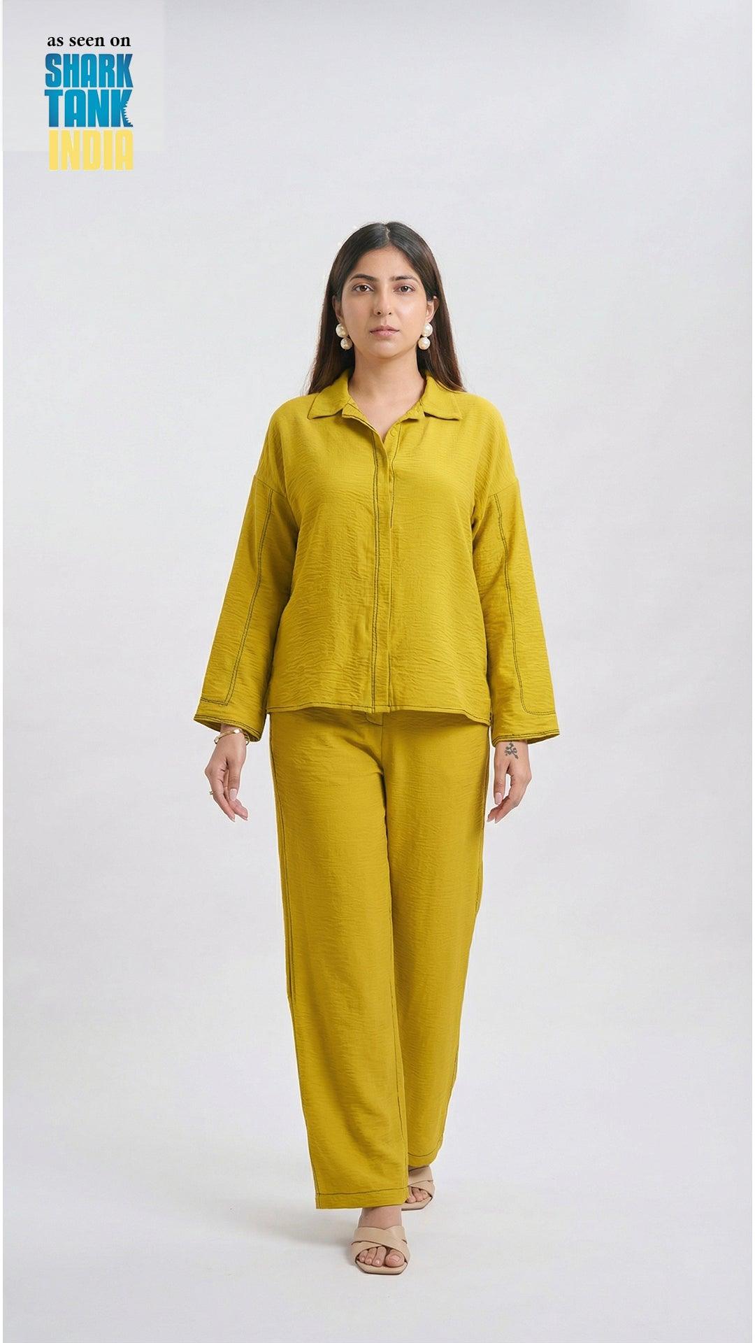 Woman wearing a mustard yellow outfit on a white background with 'Shark Tank' branding.
