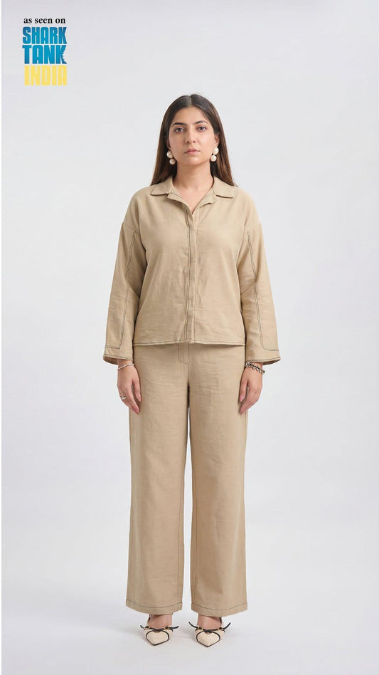 Woman wearing a beige outfit on a white background with 'Shark Tank' branding.