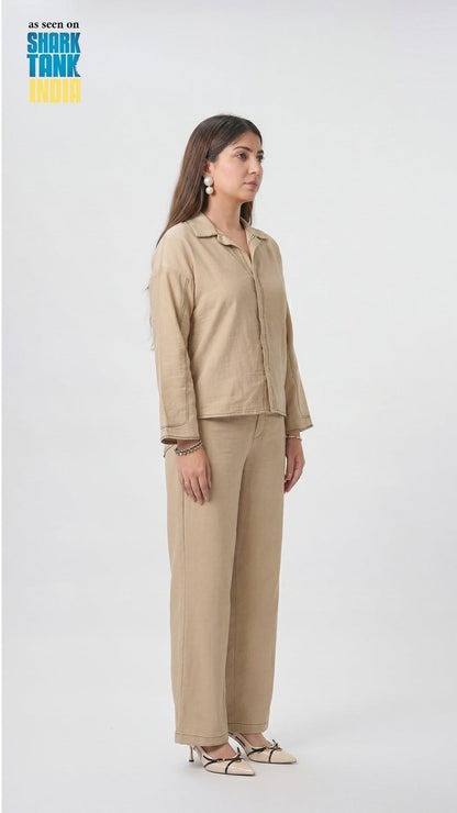 Woman wearing a beige suit with 'Shark Tank' logo in the corner