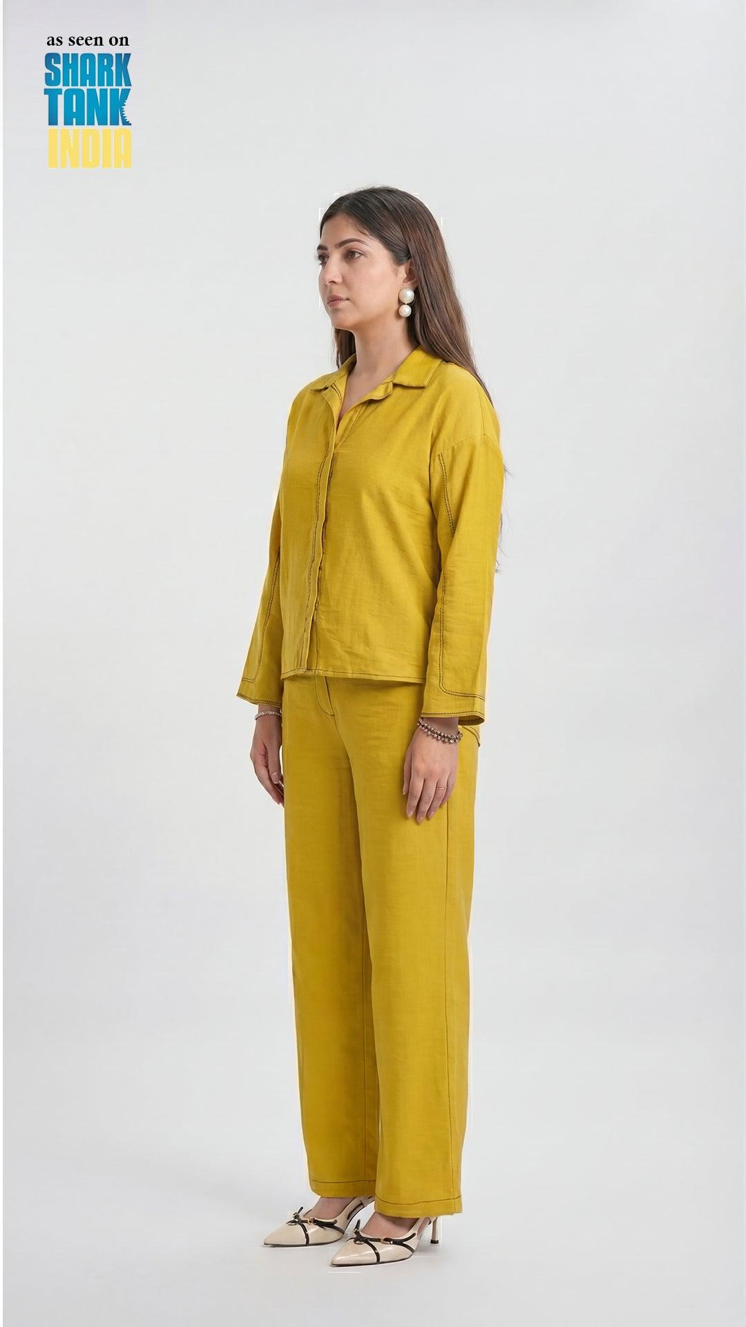 Woman wearing a mustard yellow outfit on a white background