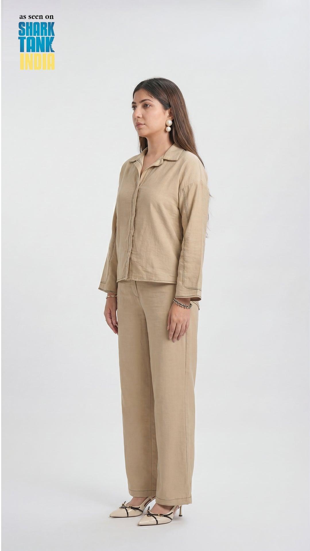Woman wearing a beige outfit on a white background with 'Shark Tank India' logo.