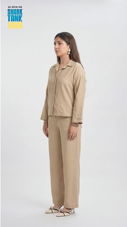 Woman wearing a beige outfit on a white background with 'Shark Tank India' logo.