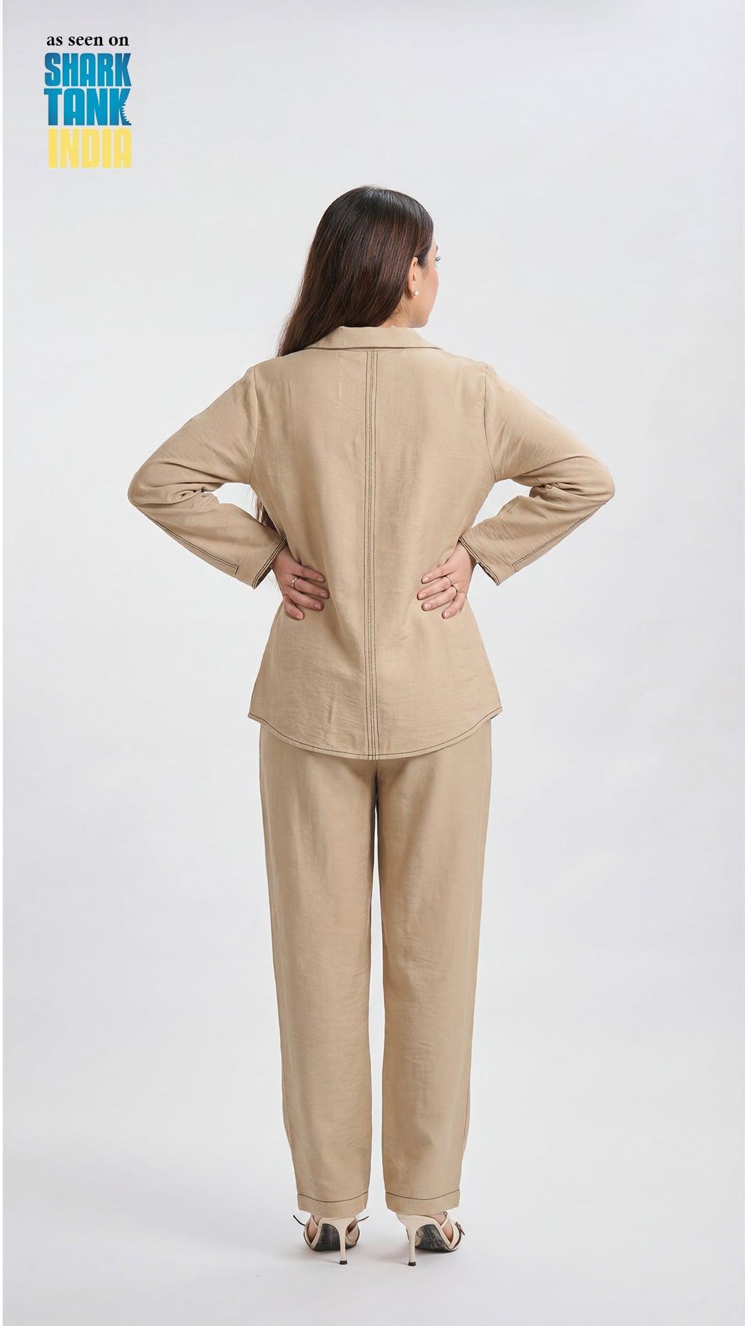Woman wearing a beige outfit on a white background with 'Shark Tank' branding.