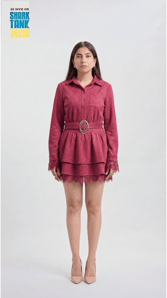 Woman wearing a red dress with a belt on a white background