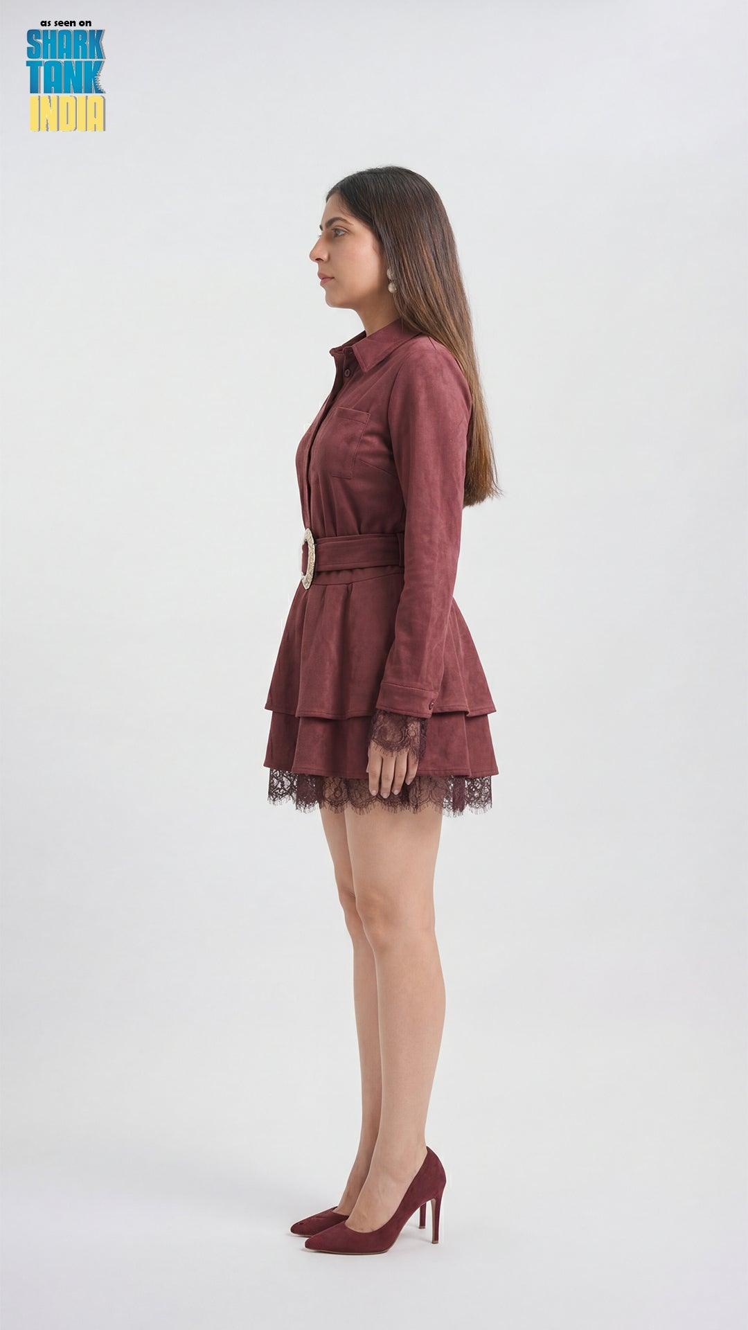 Woman wearing a burgundy dress with lace details on a white background