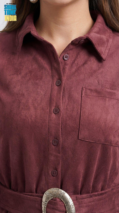 Close-up of a person wearing a maroon shirt with a belt buckle.