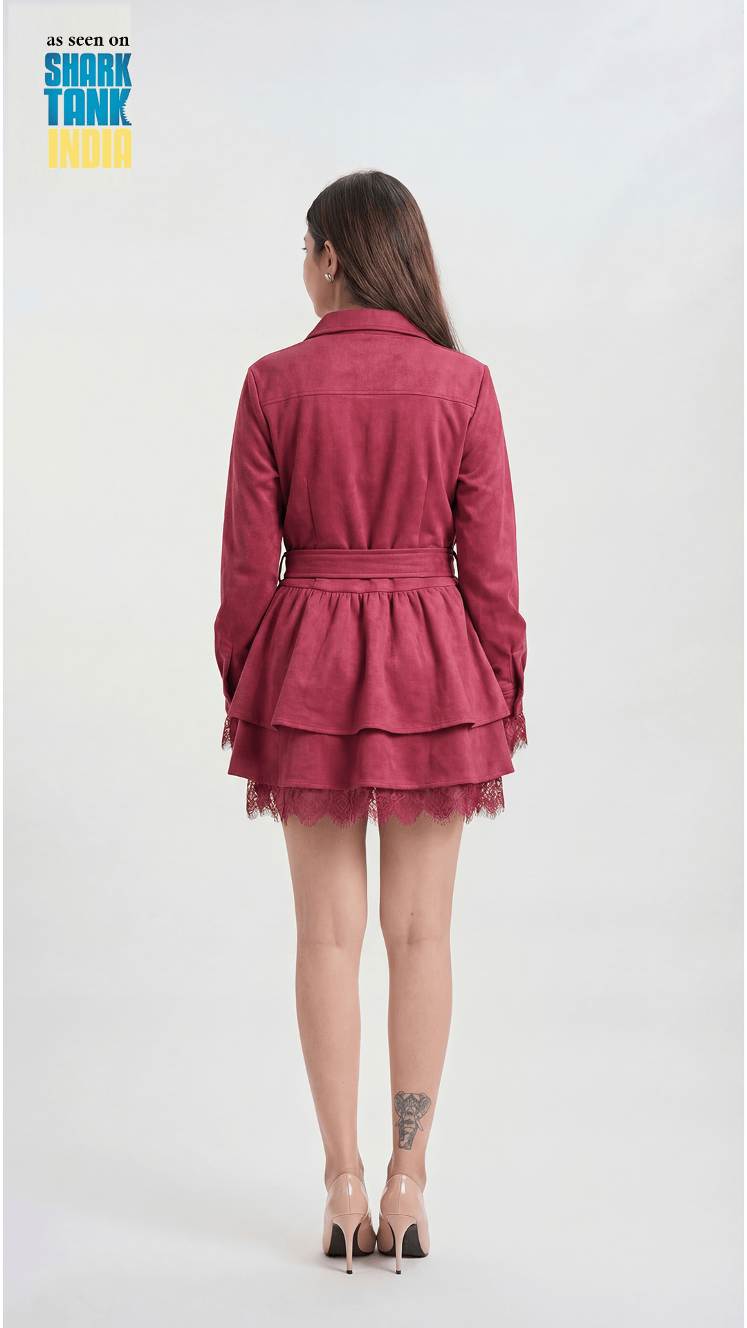 Person wearing a red dress with lace details on a white background