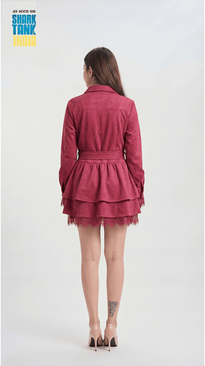 Person wearing a red dress with lace details on a white background