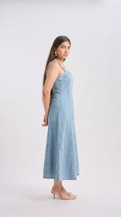Woman wearing a light blue dress against a white background