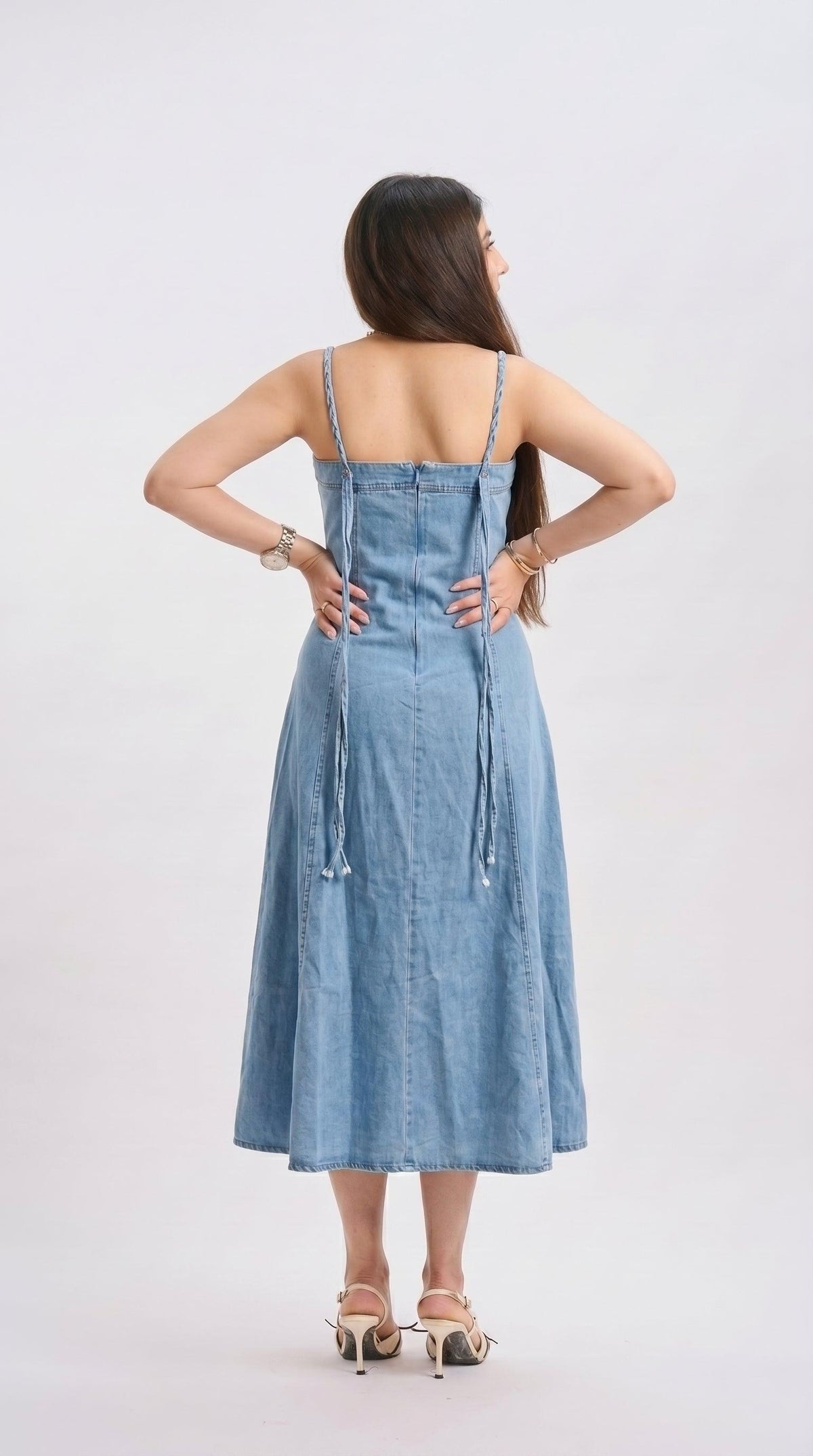 Woman wearing a denim dress on a white background