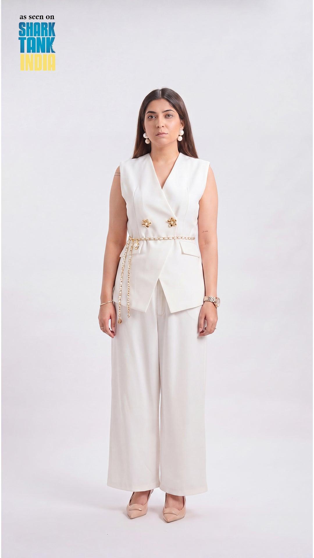 Woman wearing a white outfit with gold accents on a white background