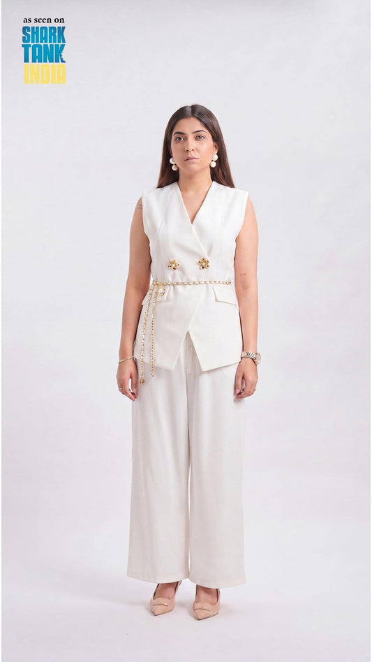 Woman wearing a white outfit with gold accents on a white background
