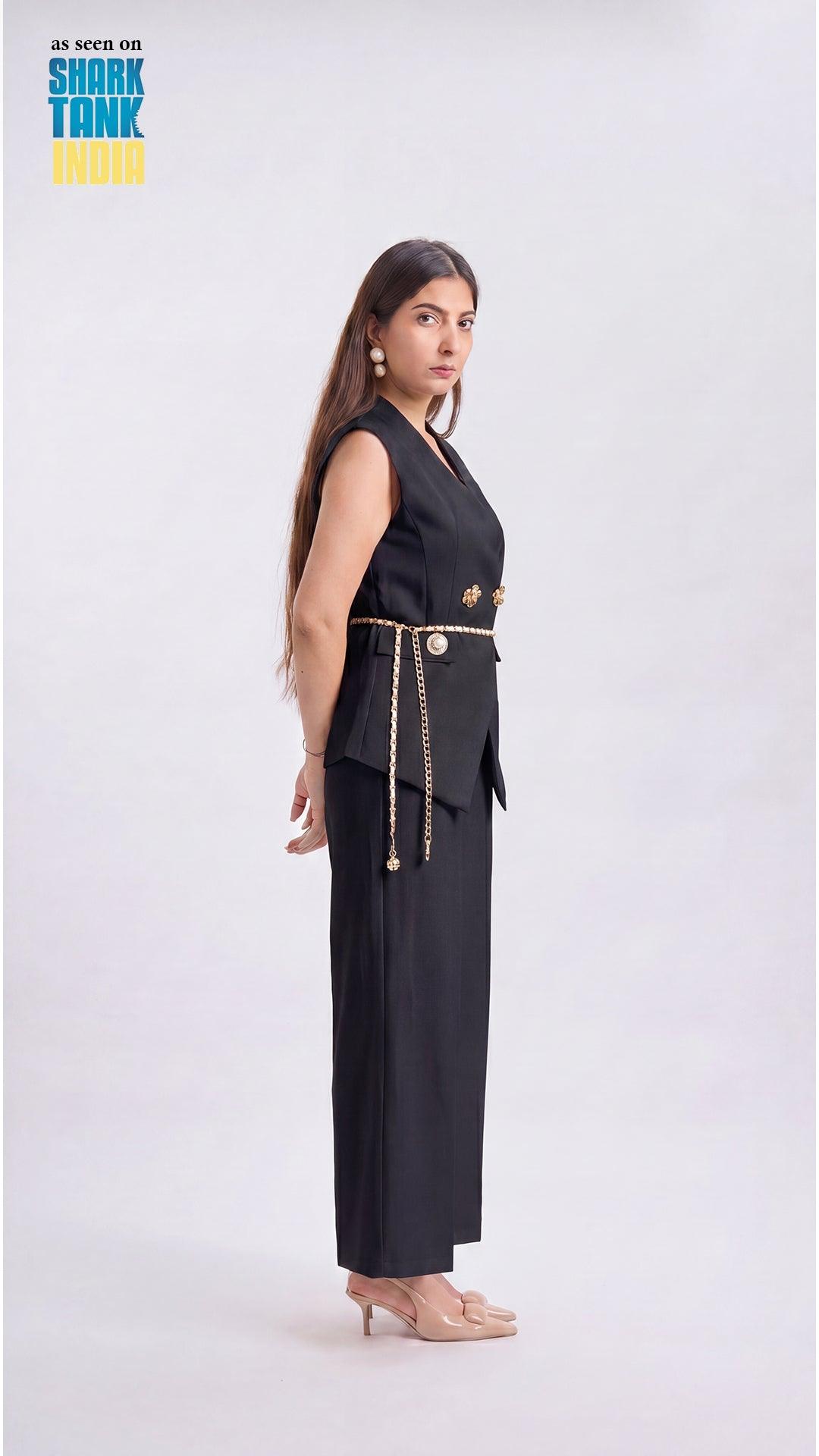 Woman wearing a black outfit with gold accents on a white background