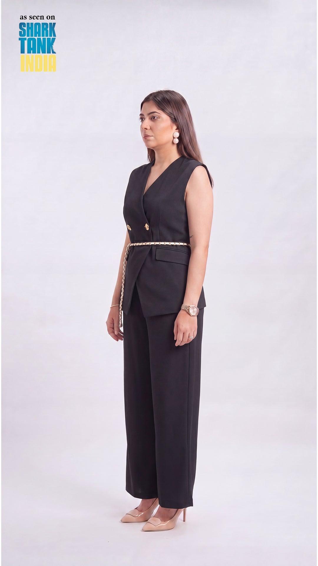 Woman wearing a black outfit with gold accents on a white background