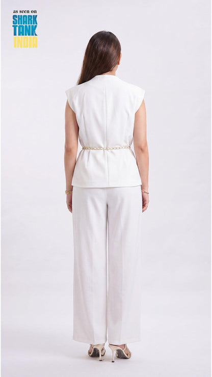 Woman wearing a white outfit on a plain background with 'Shark Tank' branding.