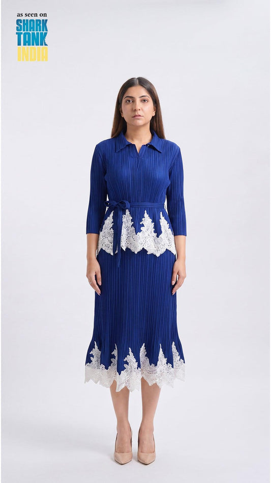 Woman wearing a blue dress with white lace details on a white background
