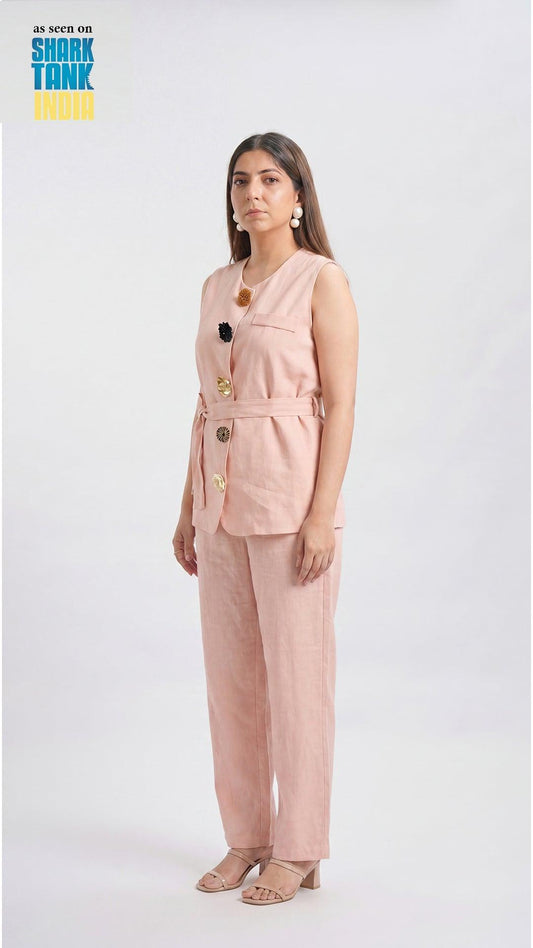Woman wearing a pink suit with 'Shark Tank India' branding in the corner.