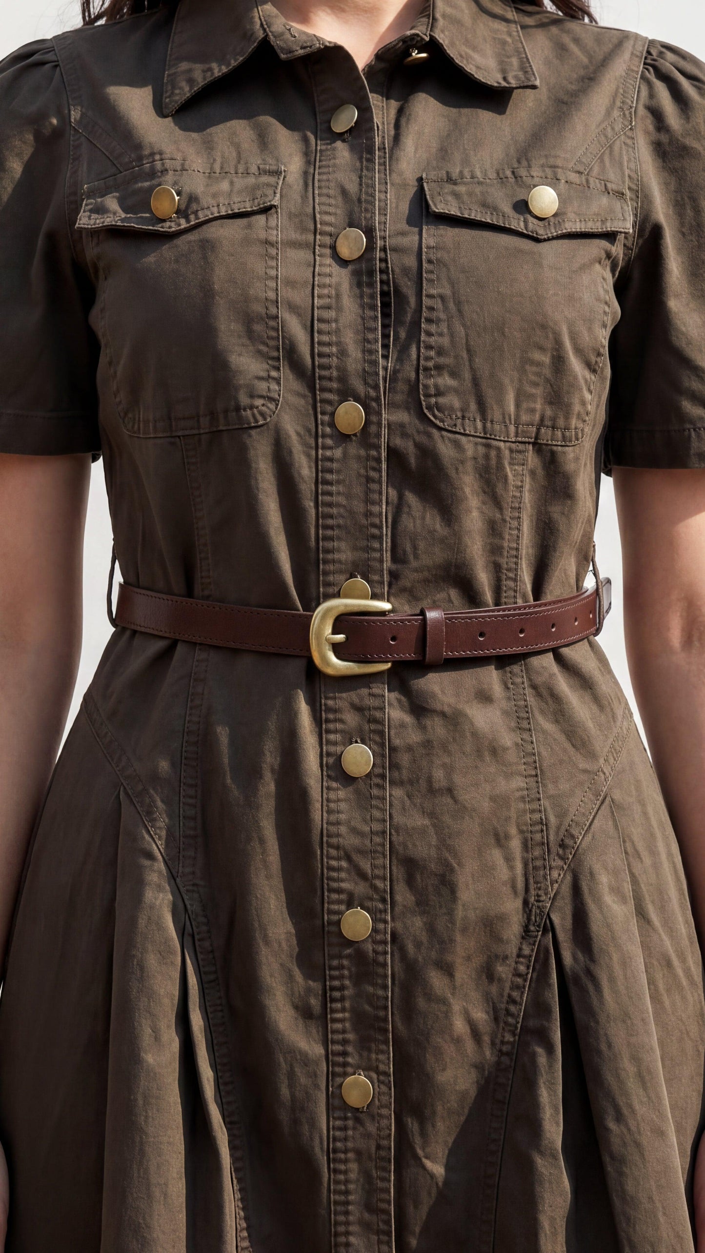 Brown dress with a belt on a neutral background