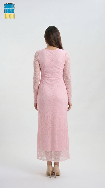 Woman wearing a pink dress with long sleeves on a white background