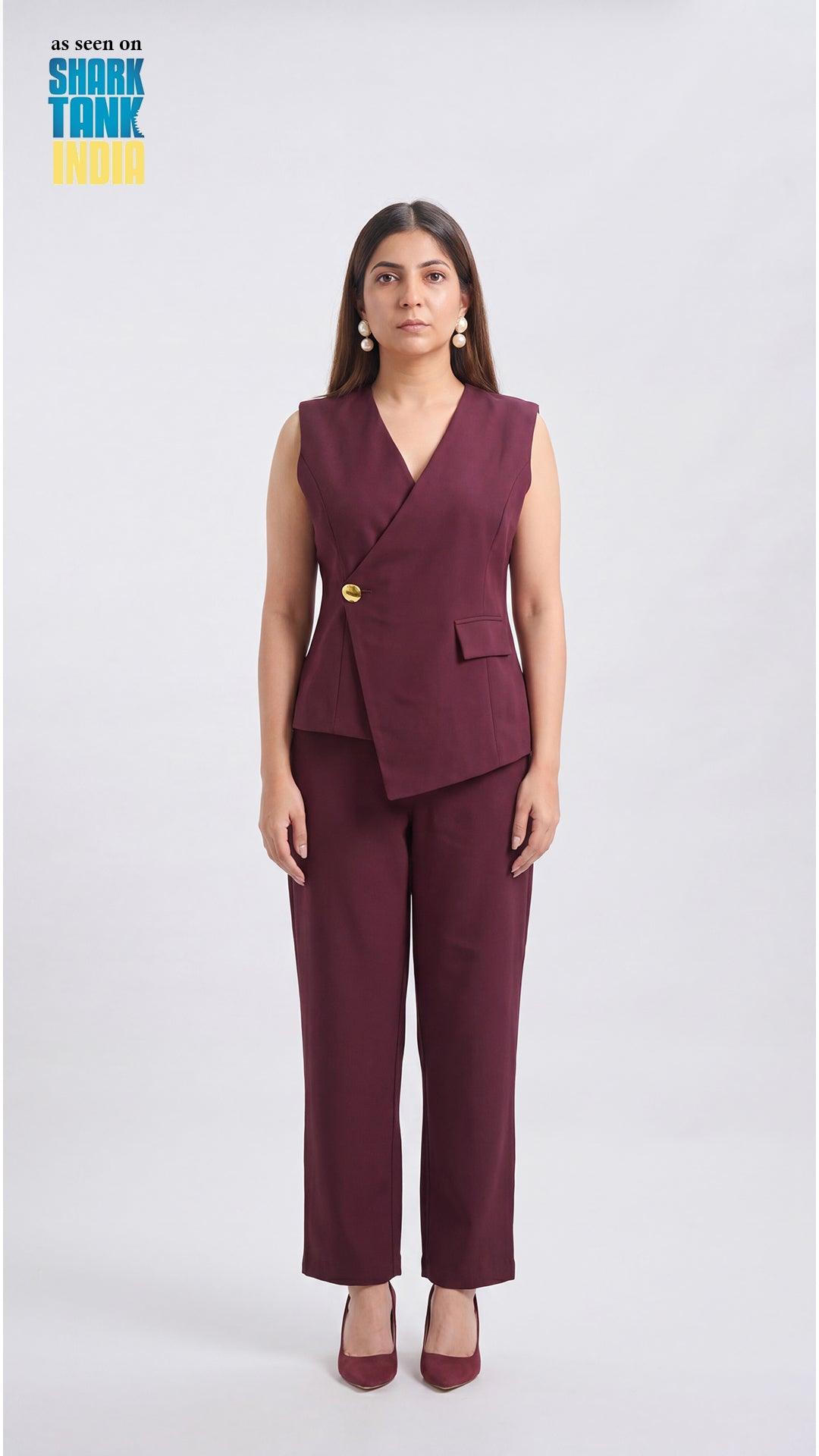 Woman wearing a burgundy suit with a vest and pants on a white background, featuring Shark Tank branding.