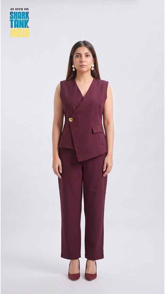 Woman wearing a burgundy suit with a vest and pants on a white background, featuring Shark Tank branding.
