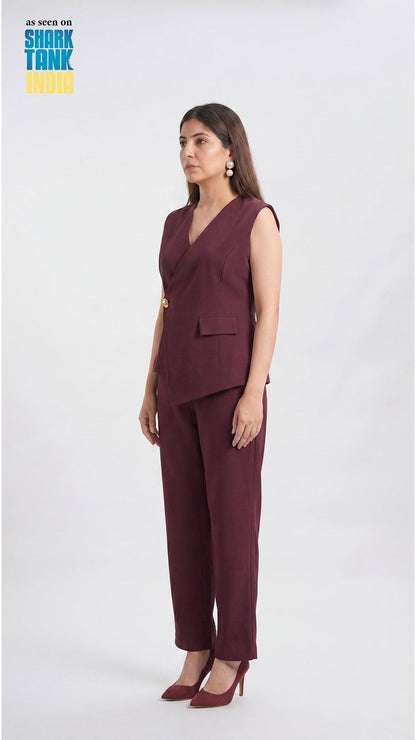Woman wearing a maroon suit with 'Shark Tank India' logo in the corner