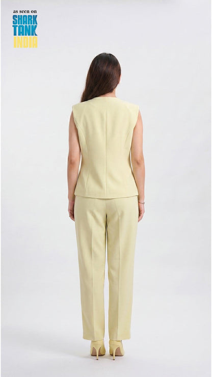 Woman wearing a light green sleeveless top and pants on a white background with 'Shark Tank' branding.