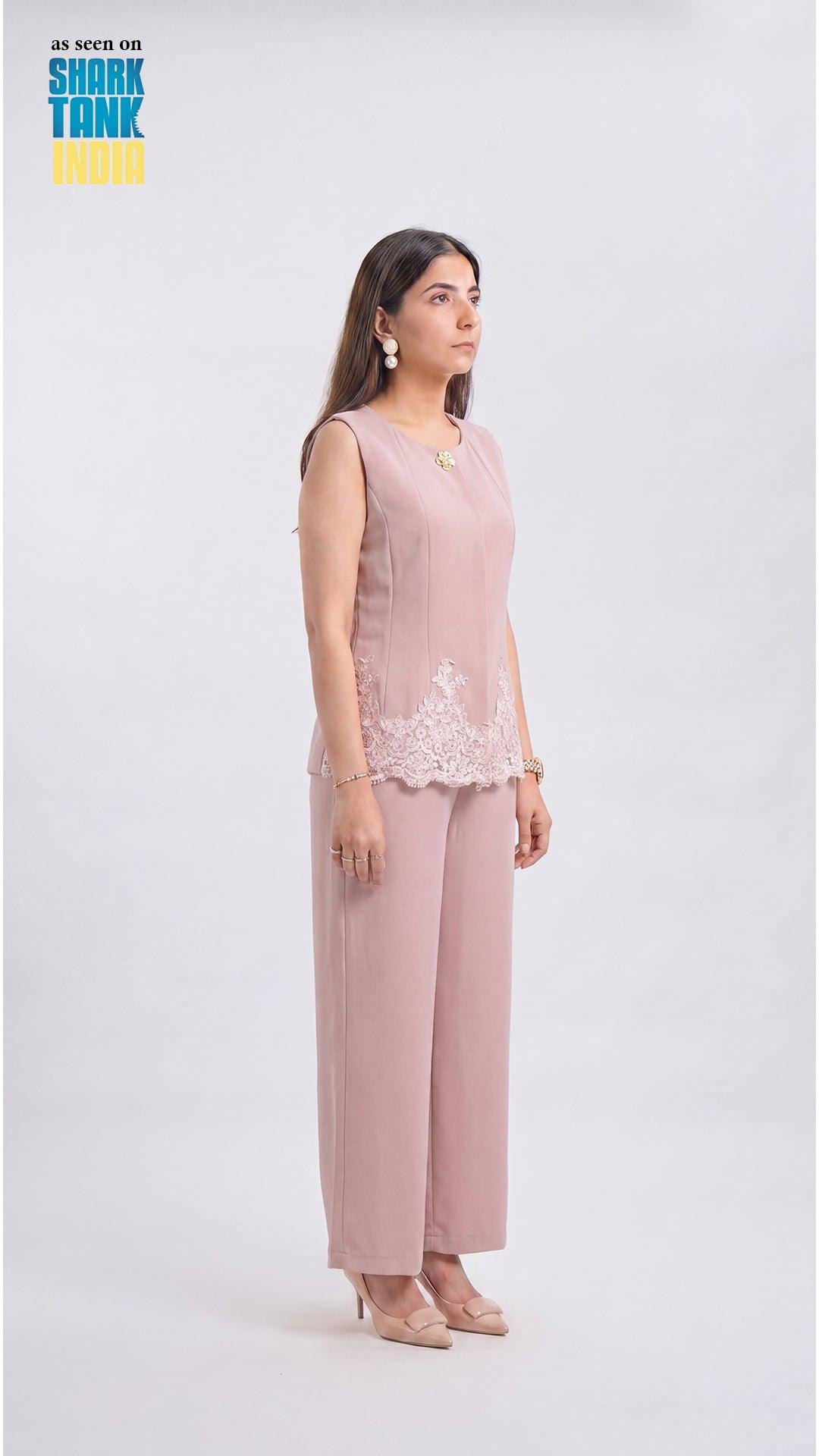 Woman wearing a pink outfit with lace details on a white background