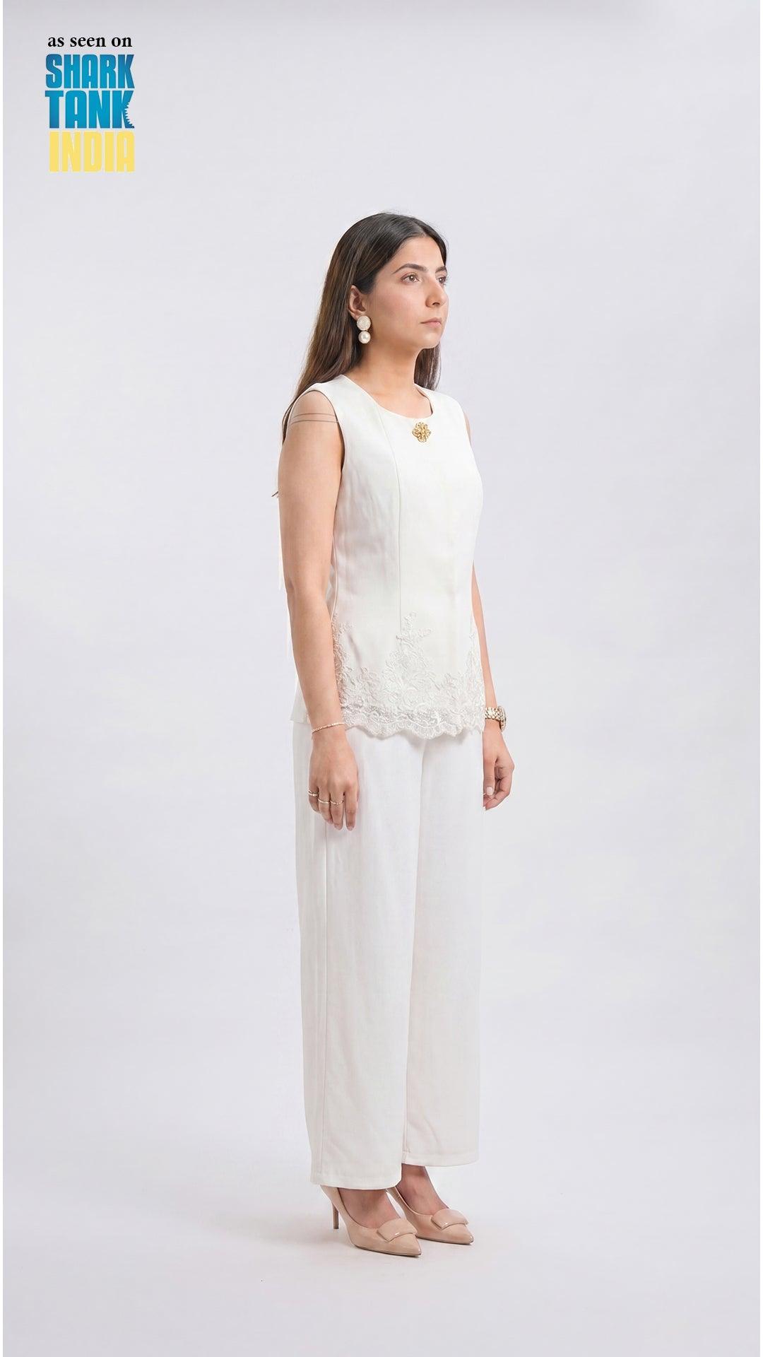 Woman wearing a white outfit on a plain background with 'Shark Tank' branding.