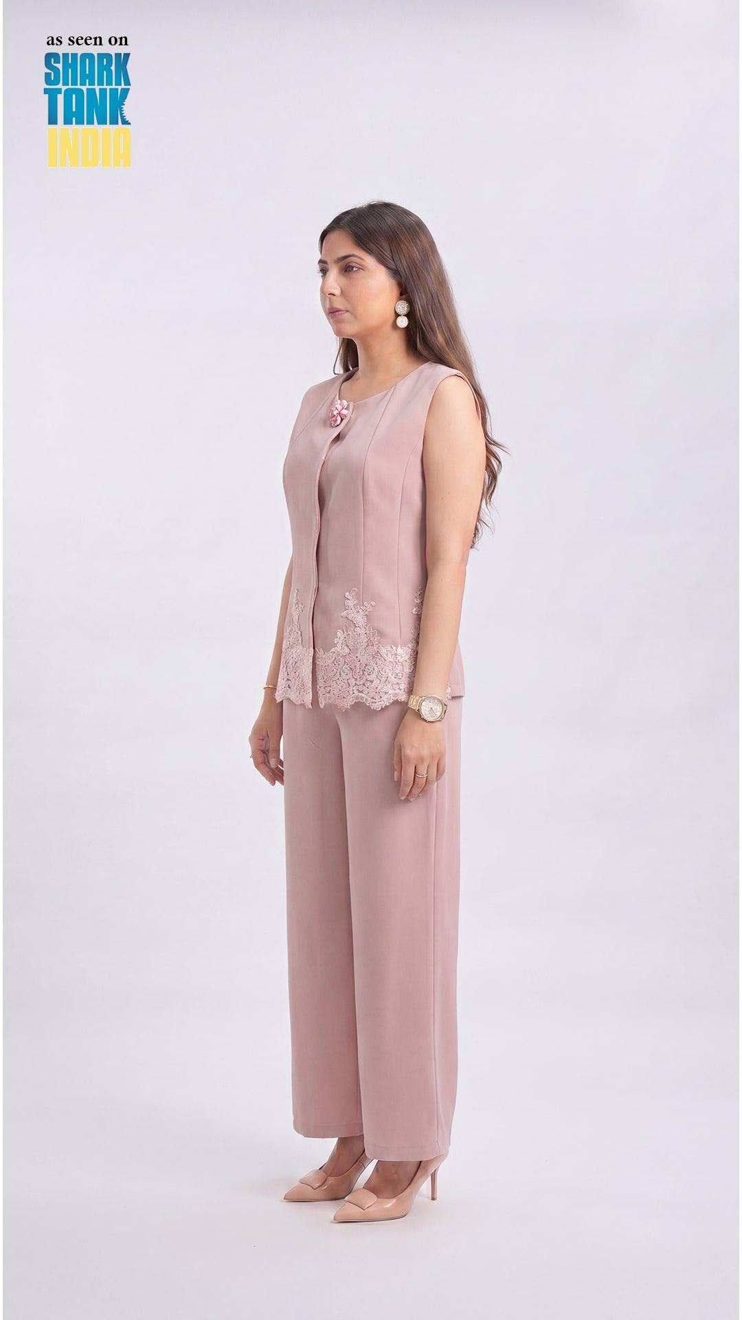 Woman wearing a pink outfit with a lace top and wide-leg pants on a white background, featuring Shark Tank branding.