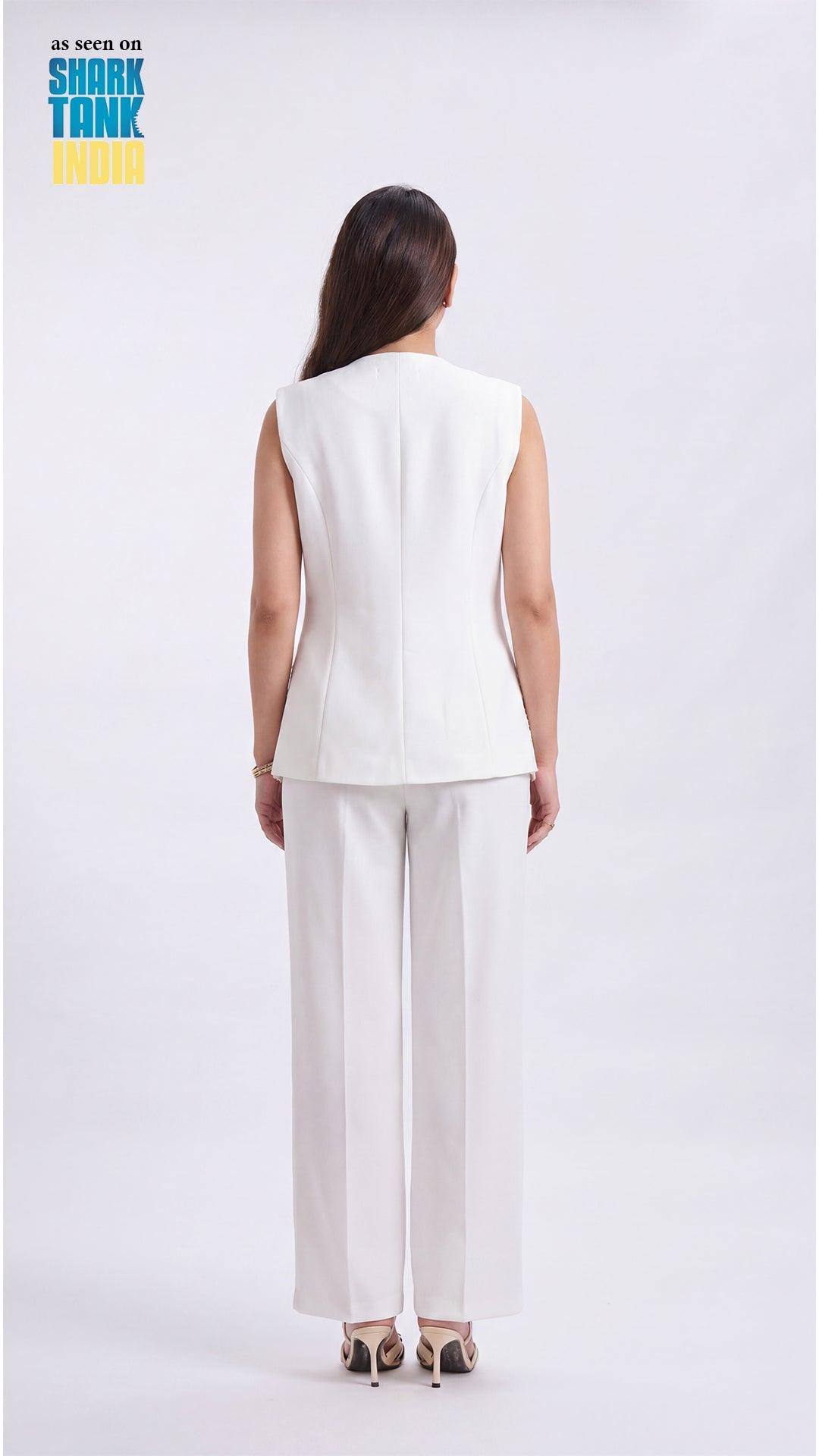 Woman wearing a white sleeveless top and pants on a white background with 'Shark Tank' branding.