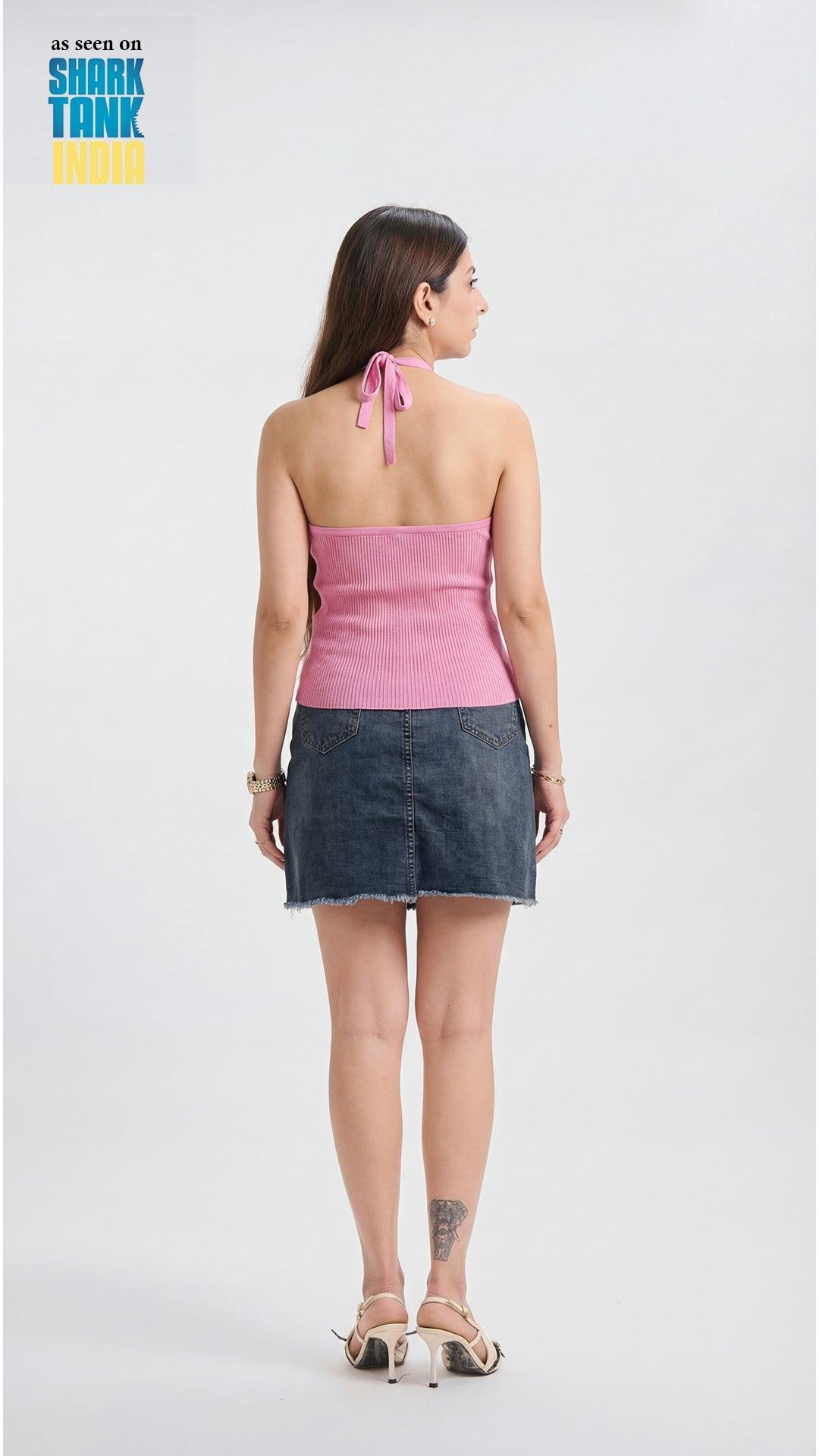 Woman wearing a pink top and denim skirt on a white background with 'Shark Tank' branding.