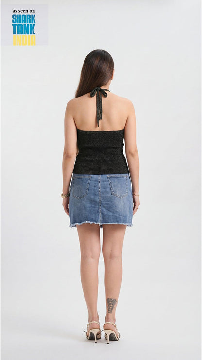 Woman wearing a black top and denim skirt on a white background with 'Shark Tank' logo.