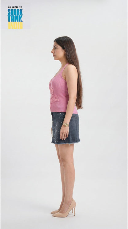 Woman wearing a pink sleeveless top and denim skirt on a white background with 'Shark Tank' branding.