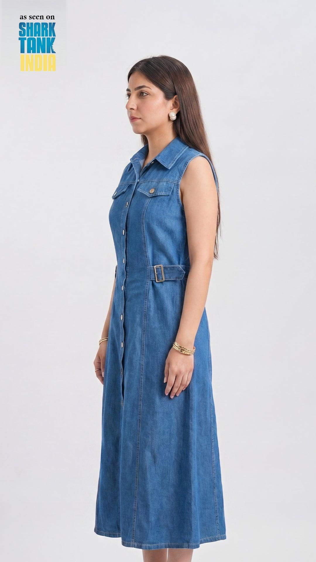 Woman wearing a blue denim dress on a white background with 'Shark Tank India' branding.
