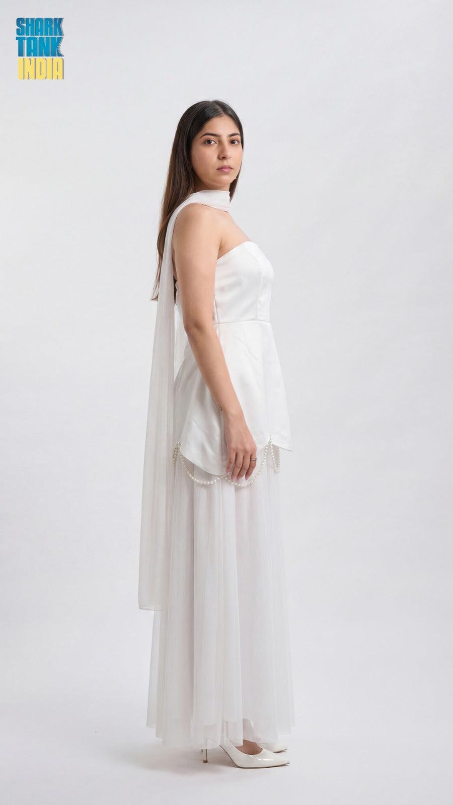Woman wearing a white dress against a white background