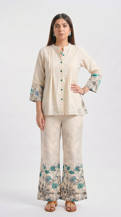 Woman wearing a beige outfit with floral patterns on a white background