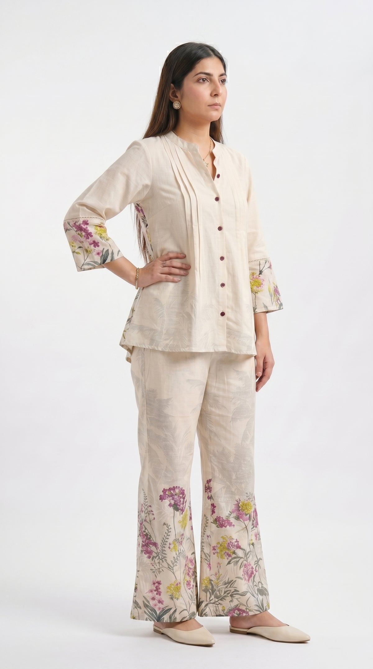 Woman wearing a beige floral outfit on a white background