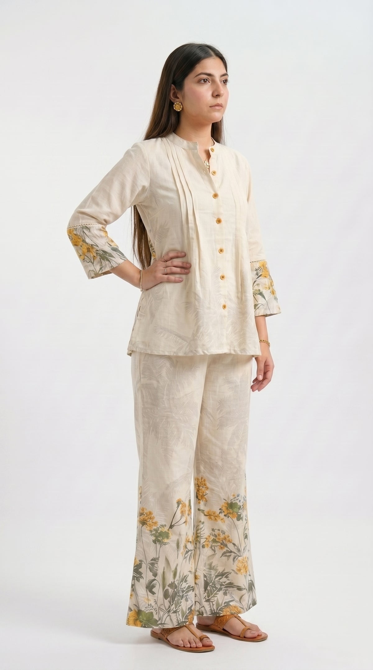 Woman wearing a beige outfit with floral patterns on a white background