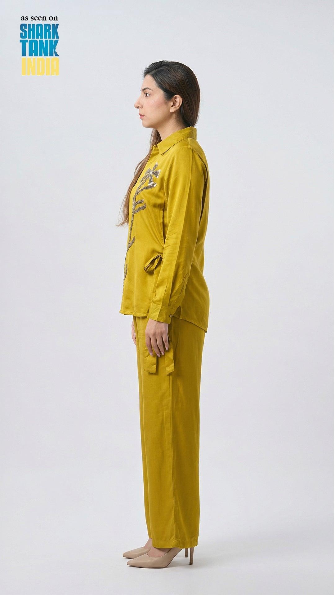 Person wearing a yellow raincoat and pants on a white background with 'Shark Tank' branding.