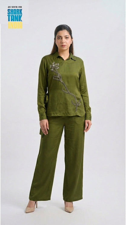 Woman wearing a green outfit with a design on a white background