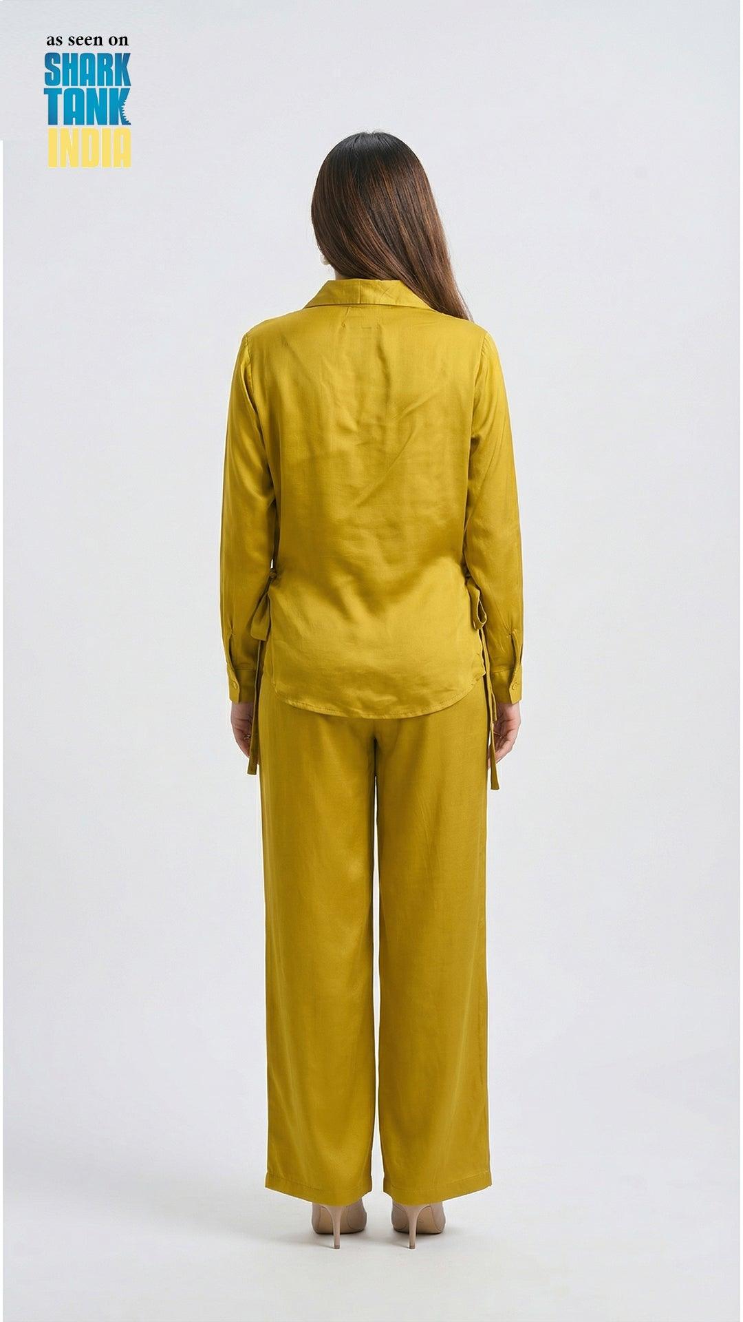 Woman wearing a mustard yellow outfit on a white background with 'Shark Tank' branding.